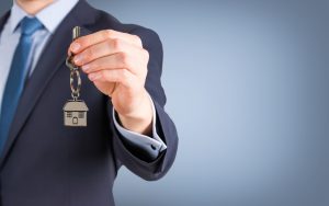 Estate agent giving house keys